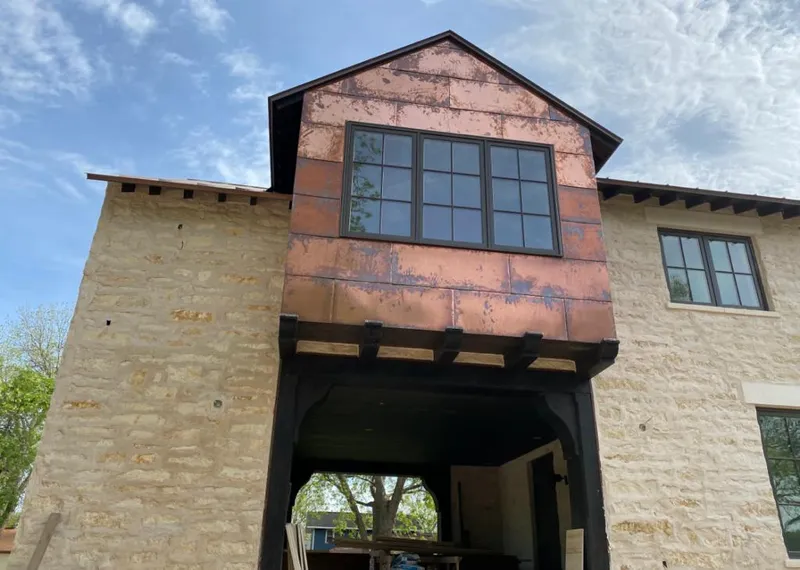 Copper metal panel facade on a stone building for Skylight Installation in French Valley